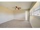 Spacious bedroom with neutral carpeting, ceiling fan, and large windows at 4173 Driver Ln, Port Charlotte, FL 33981