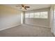 Bright bedroom featuring ceiling fan, large windows, and double door closet at 4173 Driver Ln, Port Charlotte, FL 33981