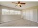 Bright bedroom featuring ceiling fan, large windows, and double door closet at 4173 Driver Ln, Port Charlotte, FL 33981