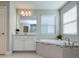 Elegant bathroom with soaking tub and white cabinetry at 4456 Tubular Run, Land O Lakes, FL 34638