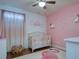 Bedroom with crib, flamingo rug, and pink accents at 4456 Tubular Run, Land O Lakes, FL 34638