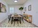 Dining room with large wooden table, black chairs, and geometric rug at 4456 Tubular Run, Land O Lakes, FL 34638