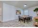 Bright dining room with wooden table, black chairs, and geometric rug at 4456 Tubular Run, Land O Lakes, FL 34638