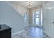 Elegant entryway with tiled floors, staircase, and view into dining area at 4456 Tubular Run, Land O Lakes, FL 34638