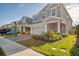 Two-story house on a tree-lined street with a gray garage door and manicured lawn at 4456 Tubular Run, Land O Lakes, FL 34638