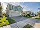 Two-story house on a tree-lined street with a gray garage door and manicured lawn at 4456 Tubular Run, Land O Lakes, FL 34638