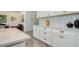 White kitchen cabinets and quartz countertops at 4456 Tubular Run, Land O Lakes, FL 34638