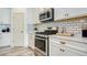 Stainless steel appliances and white shaker cabinets in this kitchen at 4456 Tubular Run, Land O Lakes, FL 34638