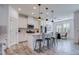 Modern kitchen with white cabinets and an island with seating at 4456 Tubular Run, Land O Lakes, FL 34638