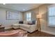 Living room with L-shaped sectional sofa and hardwood floors at 4456 Tubular Run, Land O Lakes, FL 34638