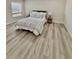 Spacious bedroom with wood-look flooring and large window at 450 S Gulfview Blvd # 408, Clearwater Beach, FL 33767