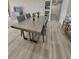 Modern dining area with gray wood floors at 450 S Gulfview Blvd # 408, Clearwater Beach, FL 33767