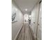 Long hallway with gray floors and artwork at 450 S Gulfview Blvd # 408, Clearwater Beach, FL 33767