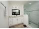 Modern bathroom with white vanity, large mirror, and walk-in shower at 4520 N Matanzas Ave, Tampa, FL 33614