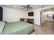 Spacious bedroom with ensuite bathroom access and a large TV at 4520 N Matanzas Ave, Tampa, FL 33614