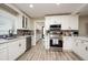 Modern white kitchen with stainless steel appliances and quartz countertops at 4520 N Matanzas Ave, Tampa, FL 33614