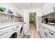 Modern laundry room with white cabinets and quartz countertops at 4520 N Matanzas Ave, Tampa, FL 33614