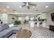 Open living room with gray sectional sofa, coffee table, and wood-look flooring at 4520 N Matanzas Ave, Tampa, FL 33614