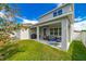 Covered patio with seating area, grill, and fenced yard at 5027 Autumn Ridge Dr, Wesley Chapel, FL 33545