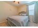 Bedroom with a queen-size bed and neutral-toned bedding at 5027 Autumn Ridge Dr, Wesley Chapel, FL 33545