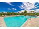 Resort-style pool with lounge chairs and palm trees at 5027 Autumn Ridge Dr, Wesley Chapel, FL 33545