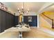 Elegant dining room features a large wooden table and a statement chandelier at 5027 Autumn Ridge Dr, Wesley Chapel, FL 33545