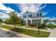 Two-story house on a tree-lined street with a manicured lawn at 5027 Autumn Ridge Dr, Wesley Chapel, FL 33545