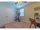 Home office with exercise bike, desk, and ample storage at 5027 Autumn Ridge Dr, Wesley Chapel, FL 33545