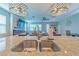 Granite kitchen island with double sink and a view into the living room at 5027 Autumn Ridge Dr, Wesley Chapel, FL 33545