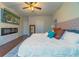 Main bedroom with king-size bed, fireplace, and walk-in closet at 5027 Autumn Ridge Dr, Wesley Chapel, FL 33545