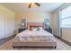 Main bedroom with king-size bed, ceiling fan, and window blinds at 5027 Autumn Ridge Dr, Wesley Chapel, FL 33545