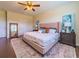 Spacious main bedroom with king-size bed and wood floors at 5027 Autumn Ridge Dr, Wesley Chapel, FL 33545