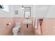 Small bathroom with pink tile, a white sink, and terrazzo flooring at 5027 Sunrise S Dr, St Petersburg, FL 33705