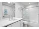 Clean bathroom with white tile, shower/tub combo at 5027 Sunrise S Dr, St Petersburg, FL 33705