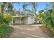 Mid-century modern home with carport and well-manicured landscaping at 5027 Sunrise S Dr, St Petersburg, FL 33705