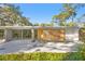 Mid-century modern home with a yellow door and a unique hexagonal patio at 5027 Sunrise S Dr, St Petersburg, FL 33705