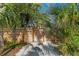 Wooden gate entry to a private and lush backyard area at 5027 Sunrise S Dr, St Petersburg, FL 33705