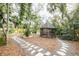 Relaxing screened gazebo nestled within a lush, secluded tropical garden at 5027 Sunrise S Dr, St Petersburg, FL 33705