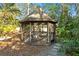 Screened gazebo with wooden deck, perfect for relaxing outdoors at 5027 Sunrise S Dr, St Petersburg, FL 33705