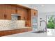 Modern kitchen with wood cabinetry, stainless steel appliances, and a large island at 5027 Sunrise S Dr, St Petersburg, FL 33705