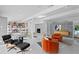 Living room with fireplace, mid-century modern furniture, and large windows at 5027 Sunrise S Dr, St Petersburg, FL 33705