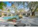 Inviting pool area with hexagonal patio, lush landscaping, and outdoor seating at 5027 Sunrise S Dr, St Petersburg, FL 33705