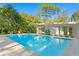 Sparkling rectangular pool surrounded by a patio and tropical landscaping at 5027 Sunrise S Dr, St Petersburg, FL 33705