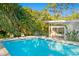 Refreshing blue pool with surrounding patio and lush greenery at 5027 Sunrise S Dr, St Petersburg, FL 33705