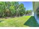 Large backyard with lush lawn and wooden fence at 5103 Ashcrest Ct, Tampa, FL 33647