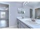 Bathroom with double vanity, updated fixtures, and bedroom view at 5103 Ashcrest Ct, Tampa, FL 33647