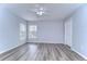 Bedroom with wood-look floors and two windows at 5103 Ashcrest Ct, Tampa, FL 33647