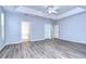 Spacious Primary bedroom with wood-look floors and multiple doors at 5103 Ashcrest Ct, Tampa, FL 33647