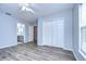 Bedroom with wood-look floors and access to bathroom at 5103 Ashcrest Ct, Tampa, FL 33647