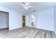 Bedroom with wood-look floors, ceiling fan, and access to bathroom at 5103 Ashcrest Ct, Tampa, FL 33647